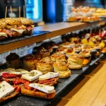 Spanish tapas called pintxos of the Basque country served on a bar counter in a restaurant in San Sebastian, Spain