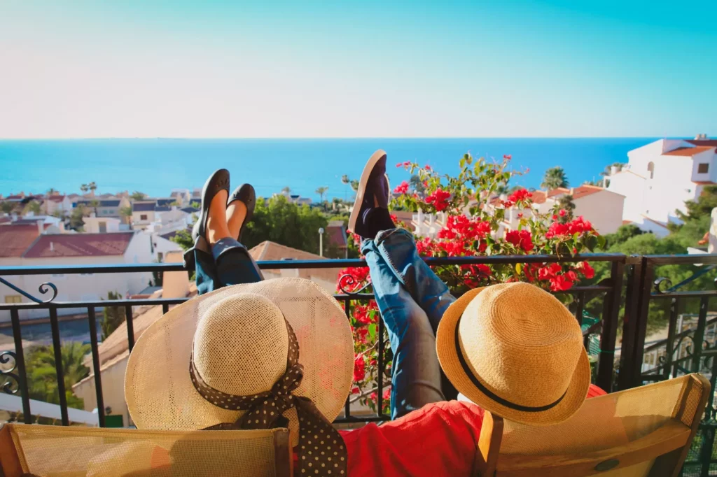 happy couple relax on balcony terrace, on vacation in Europe